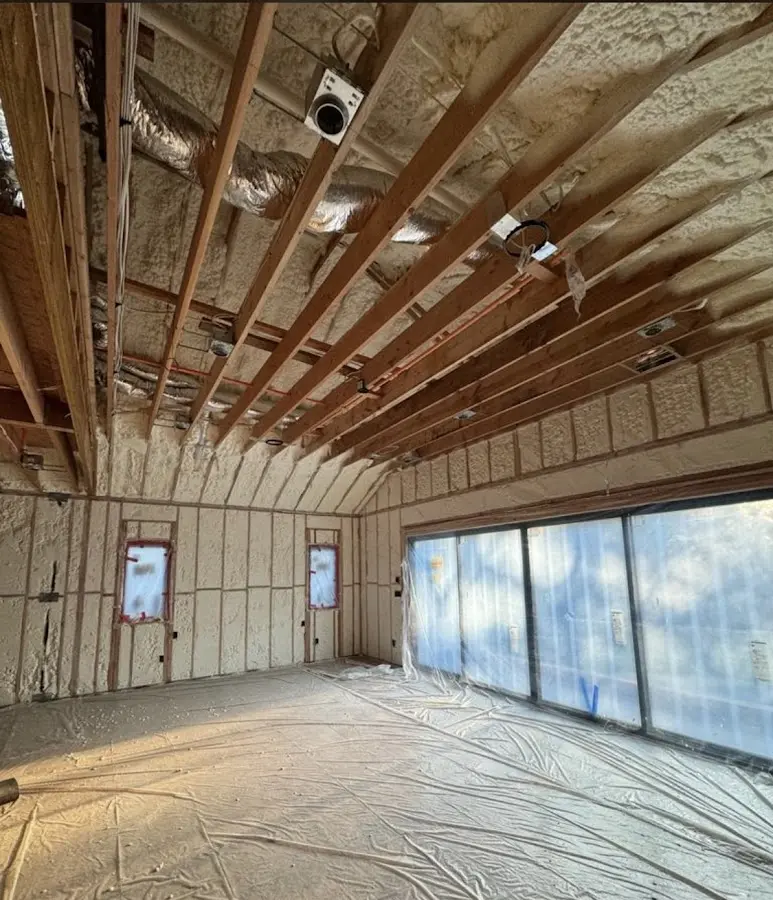 Interior walls and ceiling insulated with spray foam during new construction in East Flat Rock